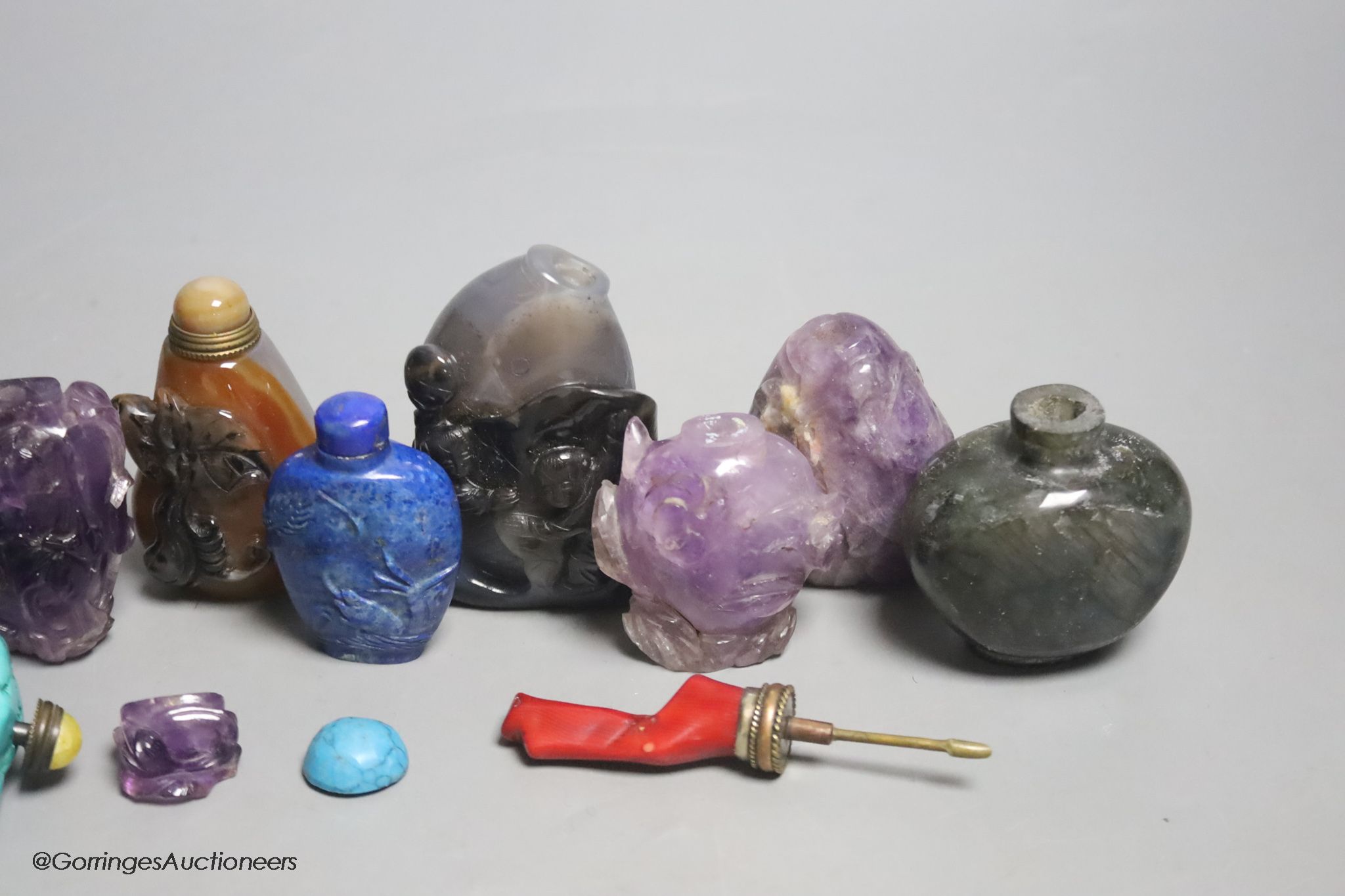 A collection of ten Chinese amethyst, lapis lazuli, turquoise and other hardstone snuff bottles